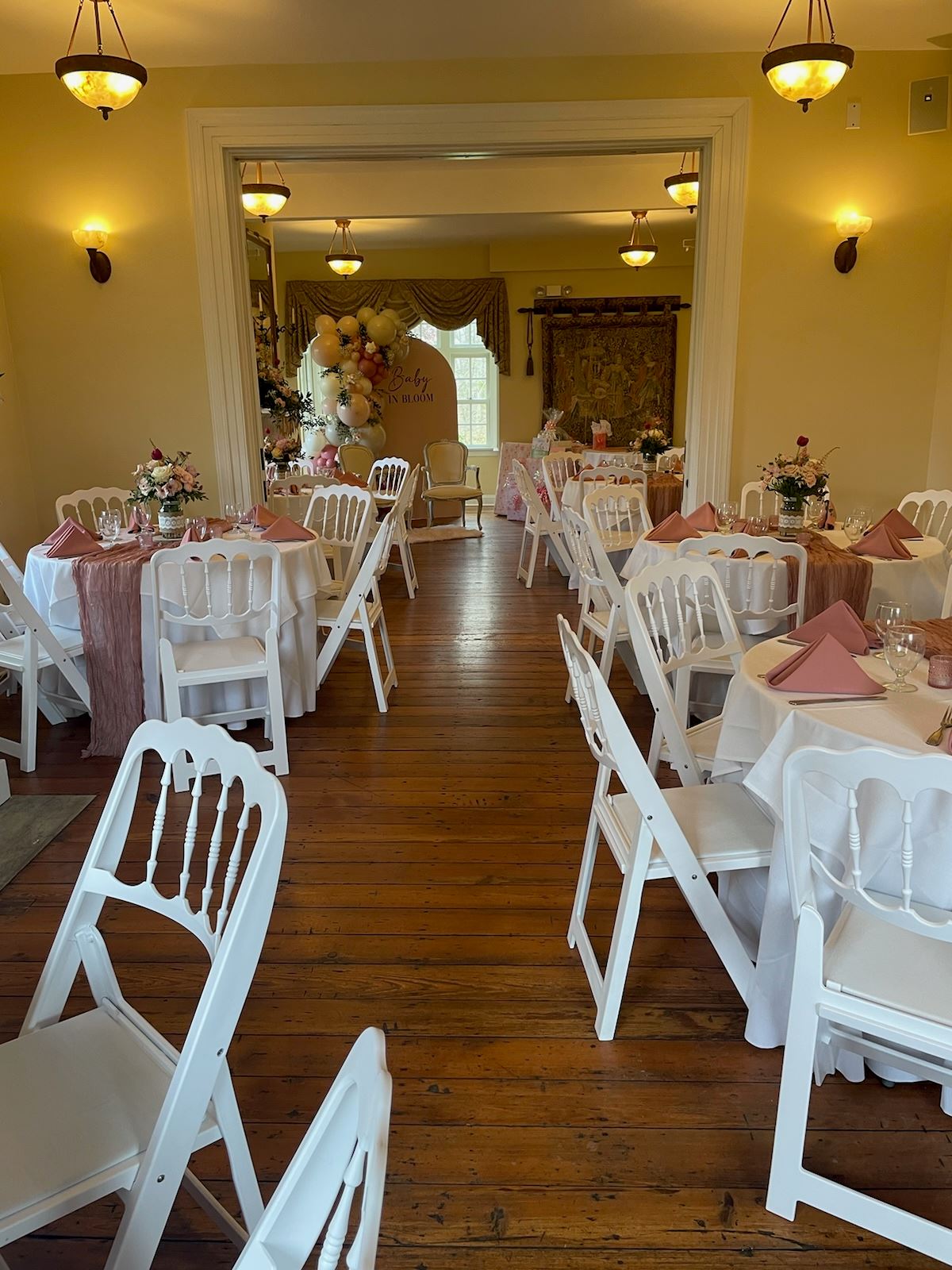 Tables with white linens and pink accents