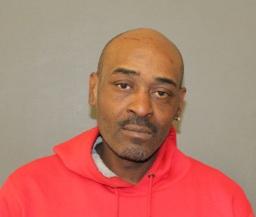 Photograph of a man in front of a neutral wall